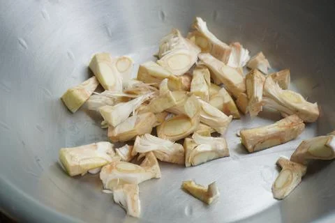 Fresh jackfruit slice being cut open, revealing its golden pulp Stock Photos