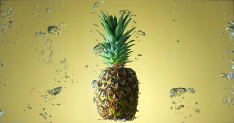 Fresh juicy pineapple rotating under water with air bubbles rising. Slow motion Stock Footage 151785629