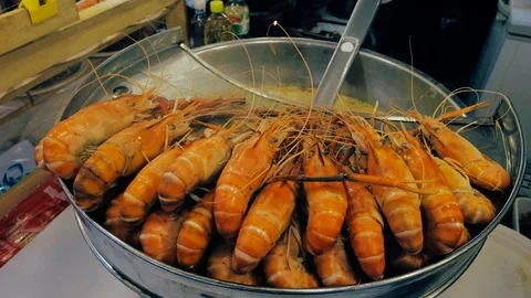 Fresh king prawns are boiled or cooked in a hot pot. Stock Footage 124570053