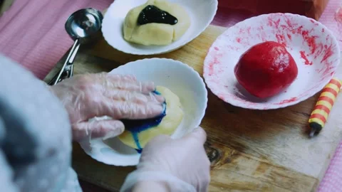 Fresh kitchen sequence of working green color into cookie dough Stock Footage 342155018