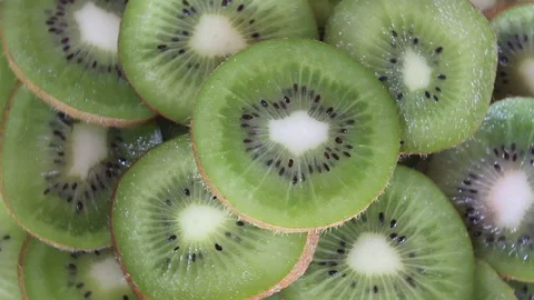 Fresh kiwi fruit slices rotating Stock Footage 88760134