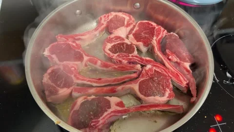 Fresh Lamb Chops Sizzling and Searing in Hot Skillet Stock Footage 346016770