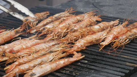 Fresh langoustines are cooked on the grill or barbecue in the fresh air Stock Footage 115967477