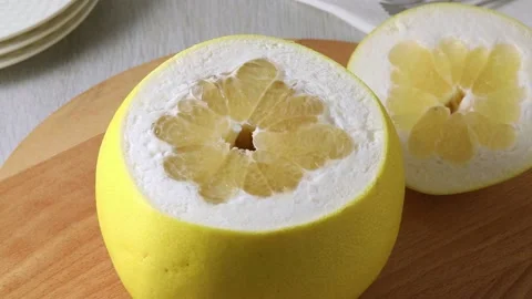 Fresh large yellow pomelo with a cut from the top Stock Footage 172143836