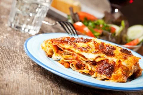 Fresh lasagna dish on a blue plate Stock Photos