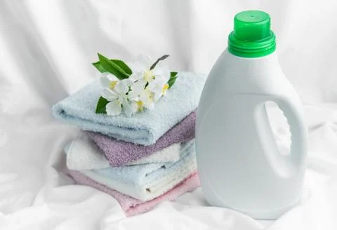 Fresh laundry concept with detergent and soft towels Stock Photos