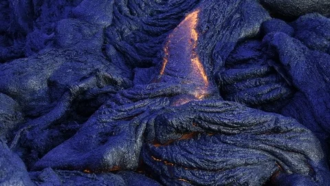 Fresh lava flows downhill, at dawn, Hawaii, creating new rock. Video stock 86184845