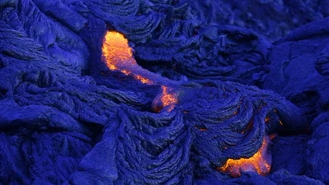 Fresh lava flows downhill, at dawn, Hawaii, creating new rock. Video stock 86184920