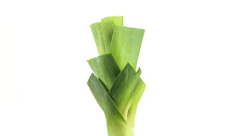 Fresh leek isolated on white background rotating Stock Footage 133436037