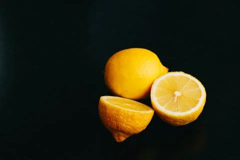 Fresh lemon on black background. two lemons. Stock Photos