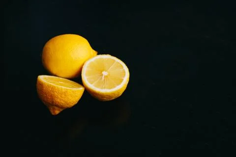 Fresh lemon on black background. two lemons. Stock Photos