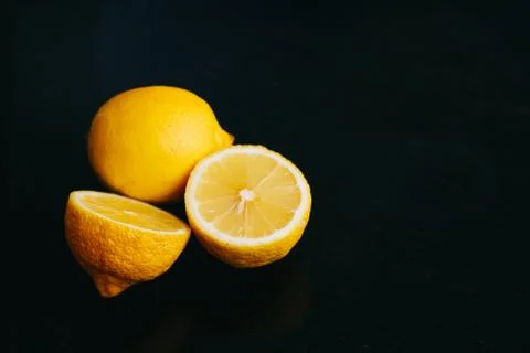 Fresh lemon on black background. two lemons. Stock Photos