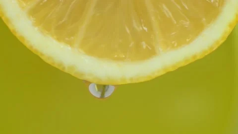 Fresh lemon cut in half. Lemon juice drips from half a lemon. Stock Footage 154556992