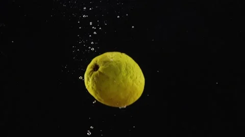 Fresh lemon floating in water with splash on black background, empty space for Stock Footage 293086009