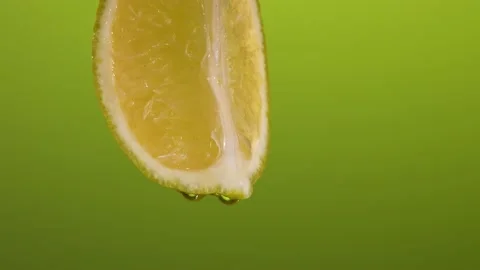 Fresh lemon on a green background. drops of water drip on the lemon. summer Stock Footage 201103070