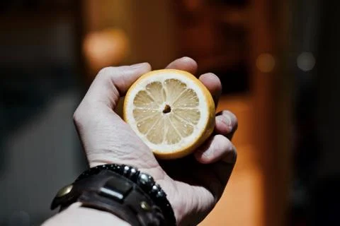 Fresh lemon in hand Stock Photos