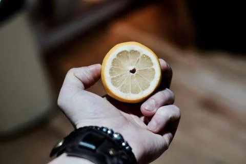 Fresh lemon in hand Stock Photos