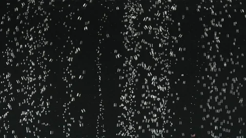 Fresh lemon slices falling into the water on black background. Citrus in water 库存影片 111415976