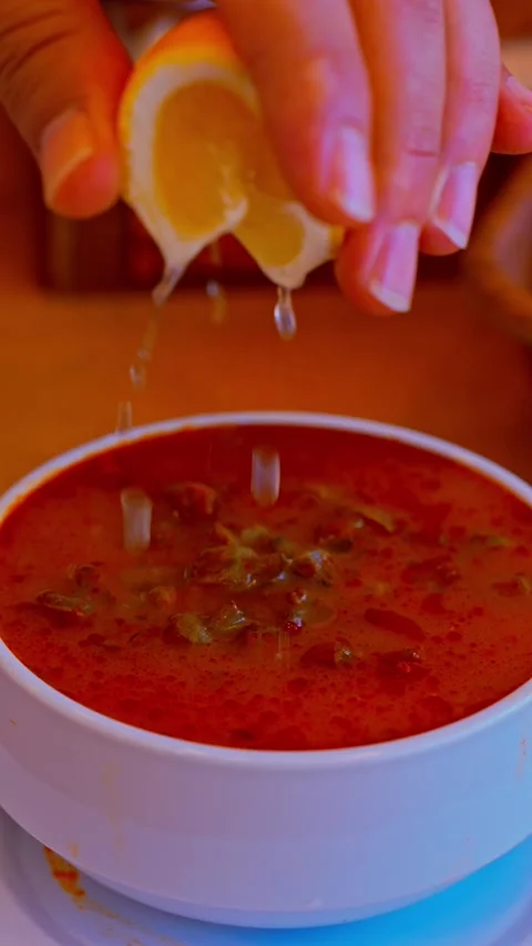 Fresh Lemon Squeezed Over Traditional Turkish Okra Soup in Restaurant Stock Footage 342557128