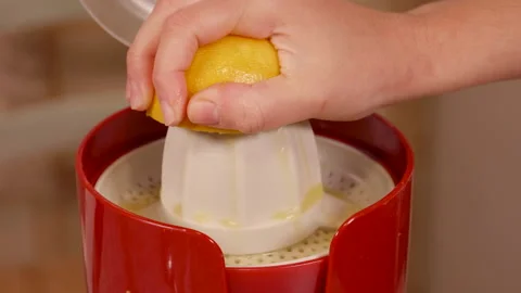 Fresh lemon squeezed by woman's hand Stock Footage 148482876