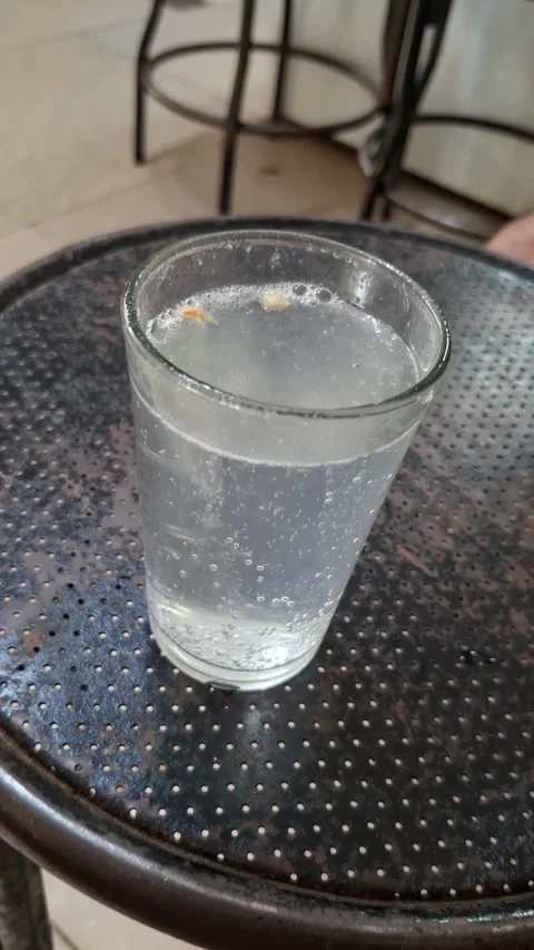 Fresh lemonade bubbling across dark tables Видео 339667131
