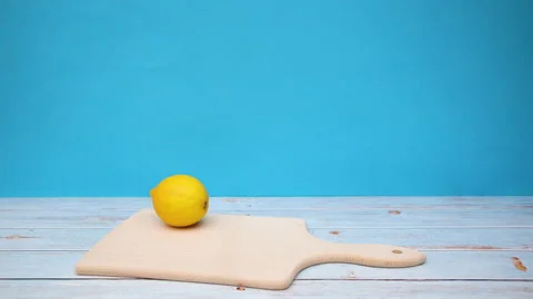 Fresh lemons appear on cutting board - Stop motion Stock Footage 130894749