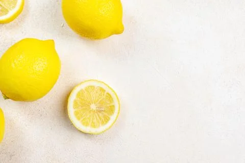Fresh lemons on bright background. Lemon fruit citrus. Composition with who.. Stock Photos