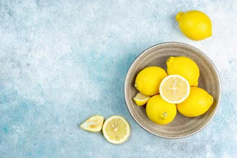 Fresh lemons on bright background. Lemon fruit citrus. Composition with who.. Stock Photos