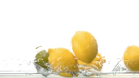 Fresh lemons falling into the water Stock Footage 123654765