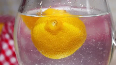 Fresh lemons floating in a pitcher of water Stock Footage 165774089