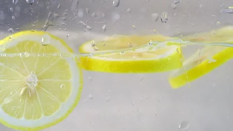 Fresh lemons floating in water with white background. Stock Footage 306960344