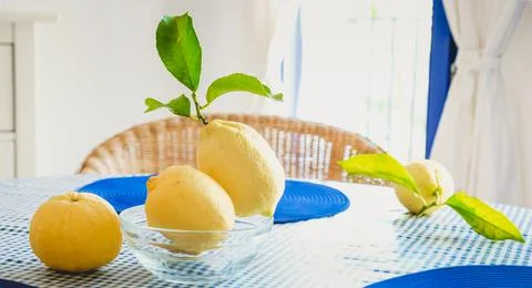 Fresh lemons with leaves on the table Stock Photos