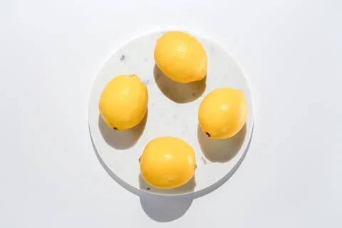 Fresh lemons on marble circle background Stock Photos