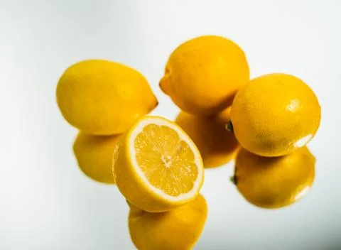 Fresh lemons reflection on mirror surface. Close up Stock Photos