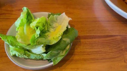Fresh Lettuce Salad with Mustard Dressing and Copy Space on Wooden Table Stock Footage 331248472