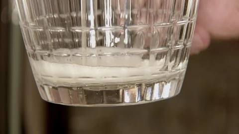 Fresh light beer is pouring into classical glass mug, close-up view, drink is Видео 107422128