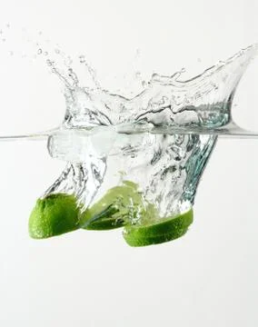 Fresh lime and ice cube splash Stock Photos