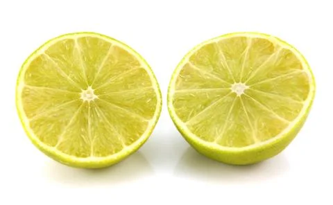 Fresh lime fruit cut in half showing cross section Stock Photos