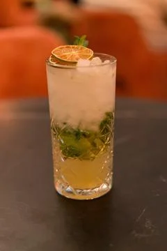 Fresh lime mint cocktail with ice in glass on bar table 스톡 사진