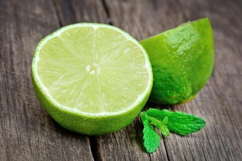 Fresh lime with mint on old table Stock Photos
