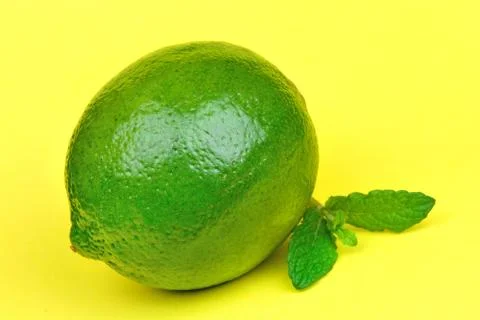 Fresh lime with mint on yellow background Stock Photos