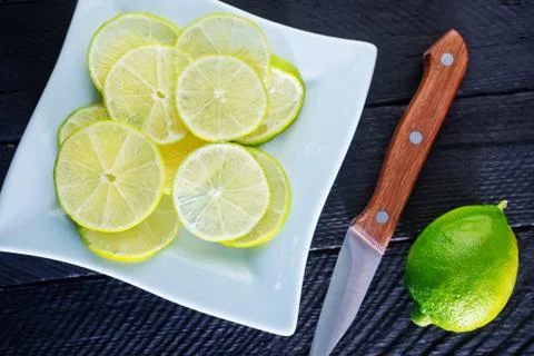 Fresh lime on plate on a table Stock Photos