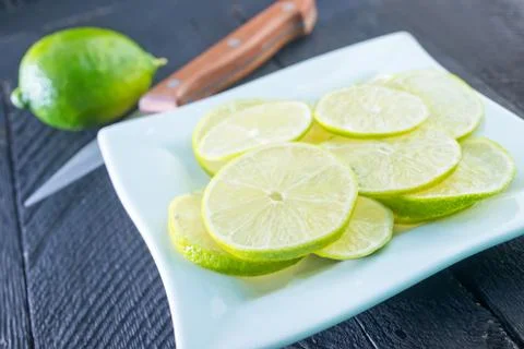 Fresh lime on plate on a table Stock Photos