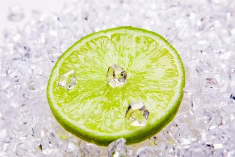 Fresh lime slices on the ice Stock Photos