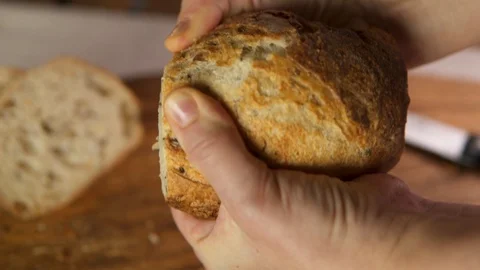 Fresh loaf is breaking in the hands. Stock-Footage 130118005