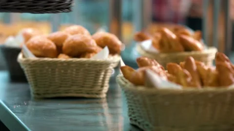 Fresh loafs of white bread in basket lying on table Stock Footage 134469100