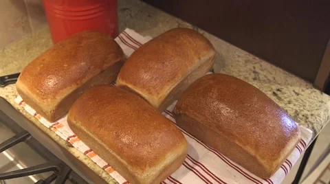 Fresh loaves of bread removed from bread pans Stock Footage 45618383