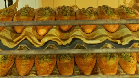 Fresh loaves of bread rest on pallets before being stocked on store shelves Stock Footage 268695901