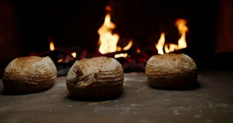 Fresh loaves of organic bread being cooked in authentic stone oven. Traditional Stock Footage 162519973