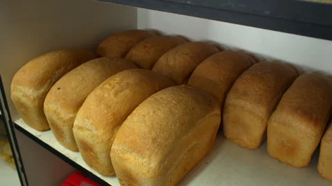 Fresh loaves of rye bread on a rustic store counter Stock Footage 119496788